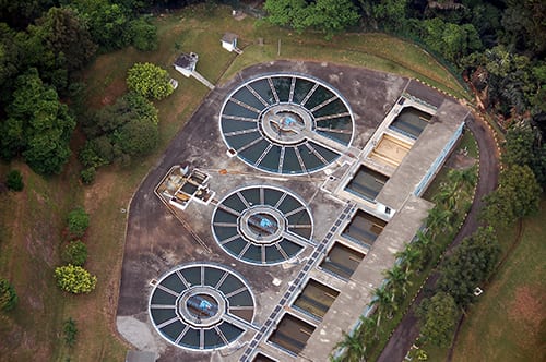 water-treatment-plant-aerial-view-showing-cicular-shape-clarifiers-and-square-filters-shutterstock_2423876